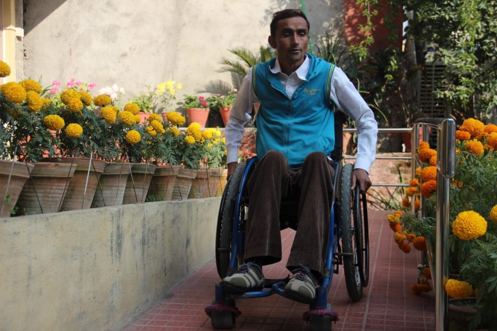 a man using wheelchair wheeling down the ramp
